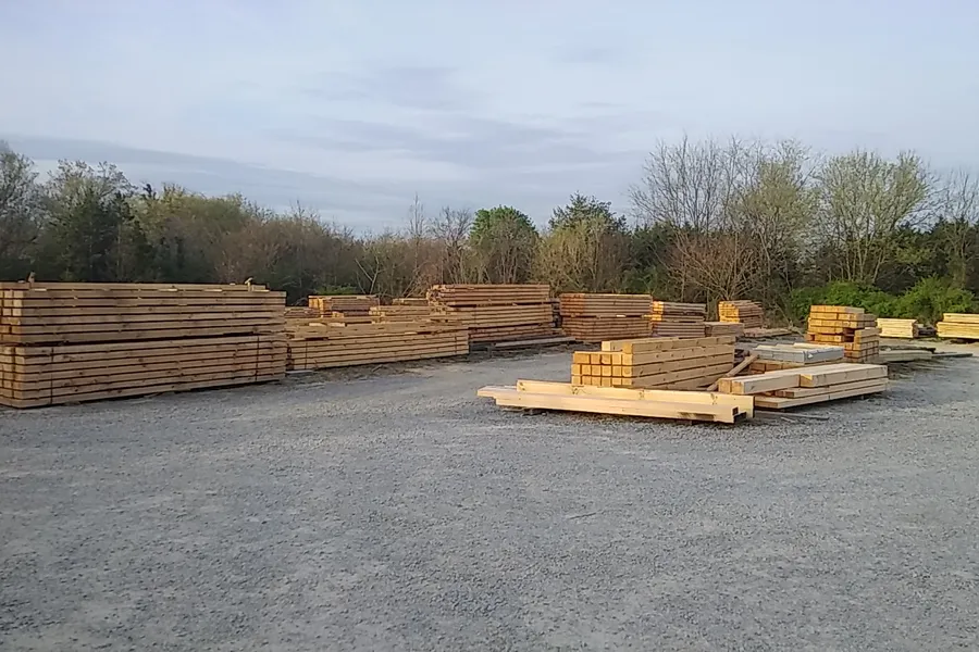 Rows of stacked timbers and beams drying in the Bivens yard